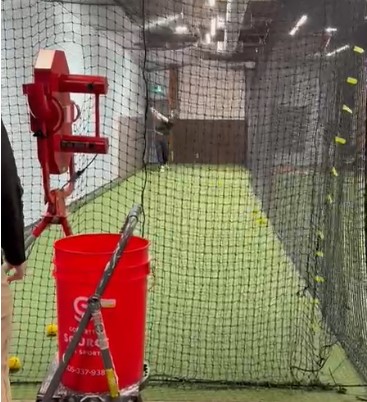 Indoor baseball batting cages with pitching machines at The Long Shot, Oakville